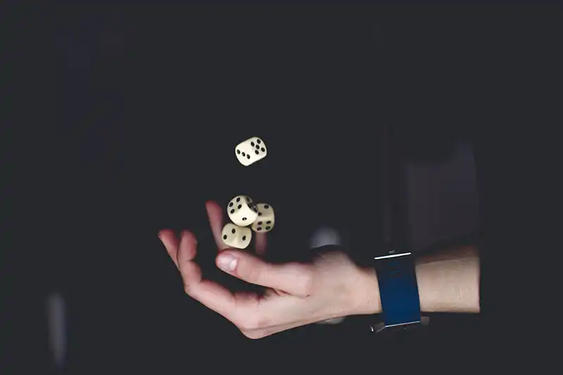 Magician hand with dice in the air