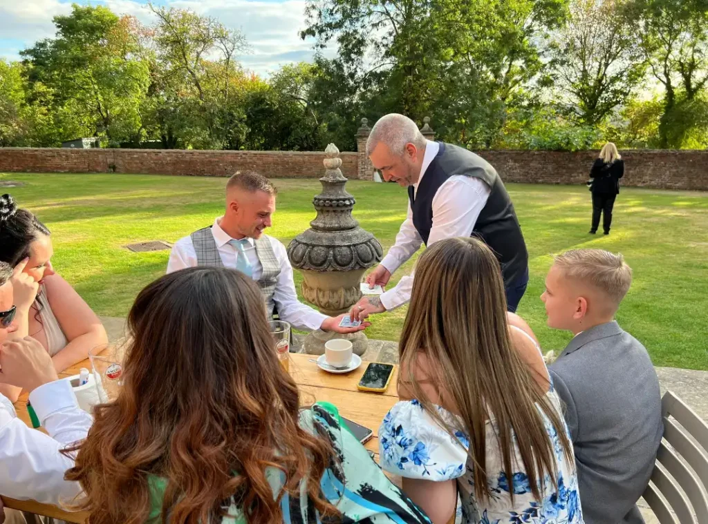 Tony performing a card trick at a Wedding event